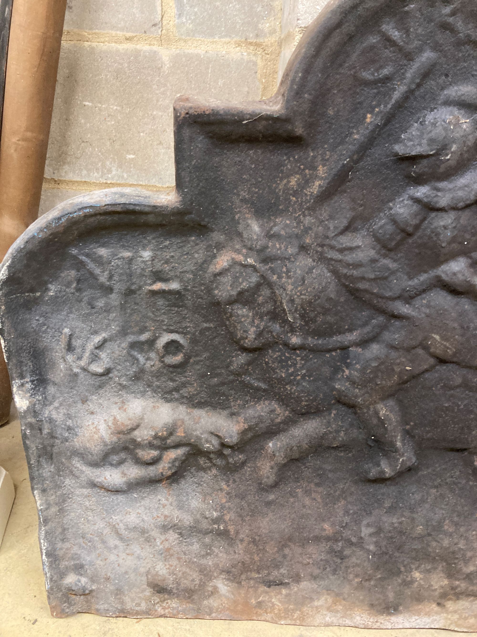 A 17th century style cast iron fireback, width 90cm, height 78cm